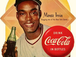Vintage Coca-Cola advertisement featuring a smiling baseball player from the New York Giants-Monte Irvin, proudly holding a bottle of Coke.