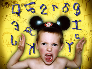 little kid with Mickey Mouse ears on, making a funny face. 1990s Christal Bird Image