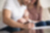 Close up of couple signing documents, young man putting signature on document, his wife si