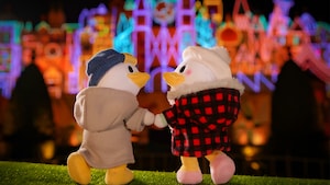 Daisy and Donald Duck NuiMOs in front of It's A Small World