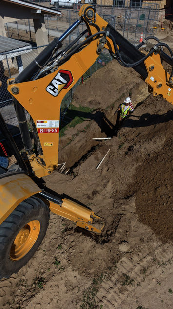 Crew checking grade in a trench