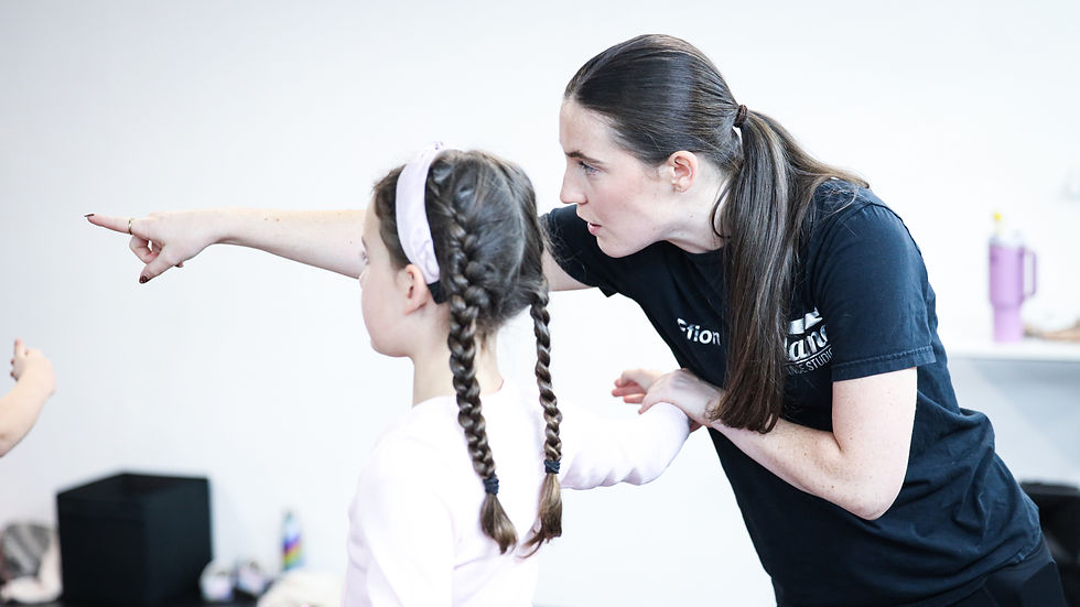 Flame Dance Studios teacher guiding a ballet dancer
