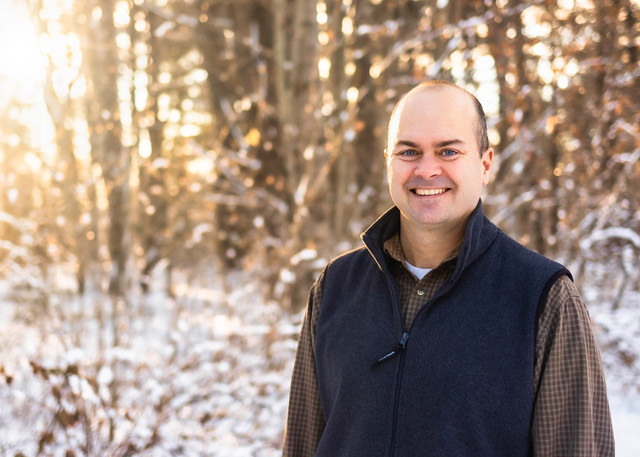 Chris Skoglund in front of snowy trees