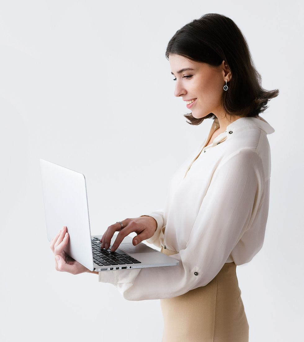 Woman standing and typing on a laptop