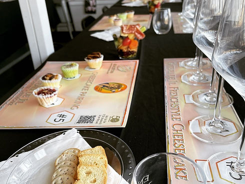 Cheesecake tasting flights with wine glasses and pairing cards
