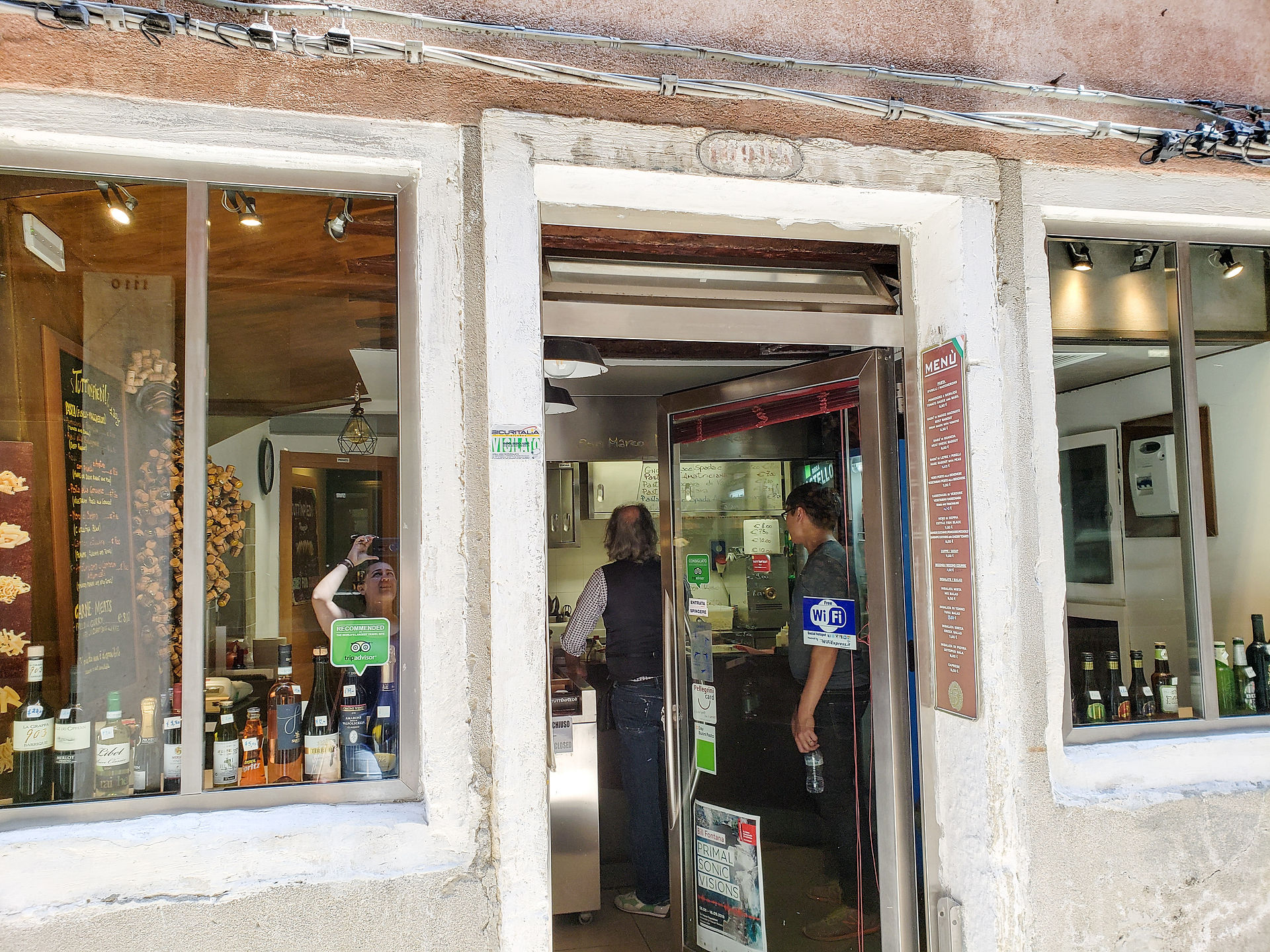 Josh inside Tuttinpiedi talking to the chef. You can see the window area where 2-4 people could sit and enjoy their food.