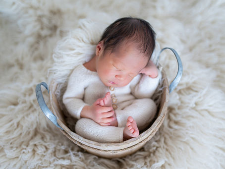 Newborn photographer in Farmington Minnesota posing baby in neutral studio