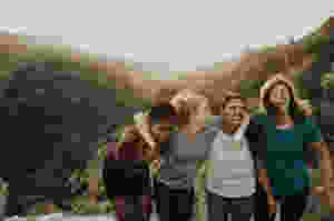 four women standing on mountain