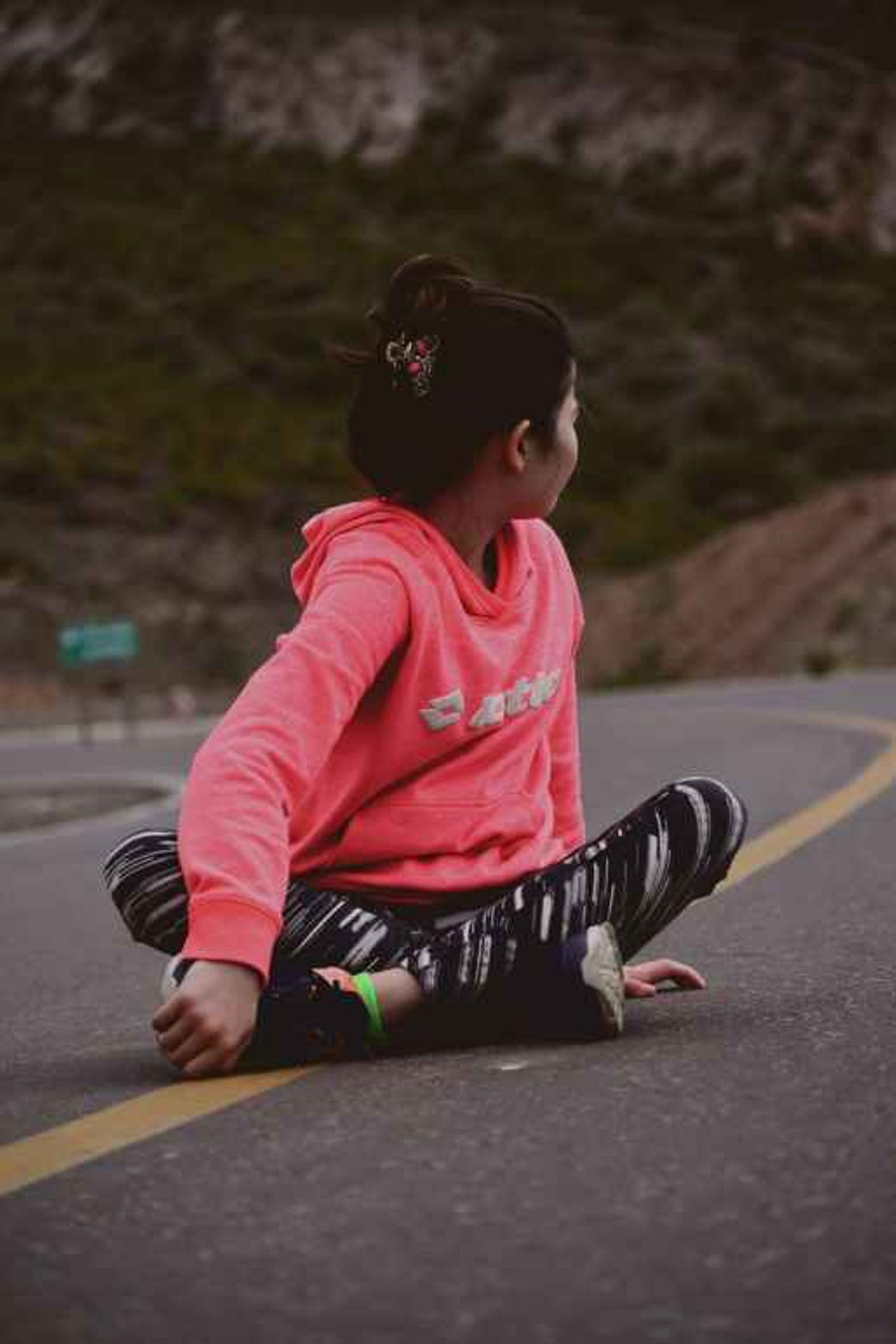 woman sitting on road