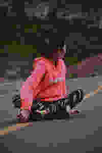 woman sitting on road