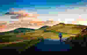 rear view of man on mountain road against sky