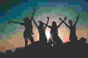 silhouette of four people against sun background
