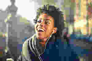 close up photo of a woman listening to music