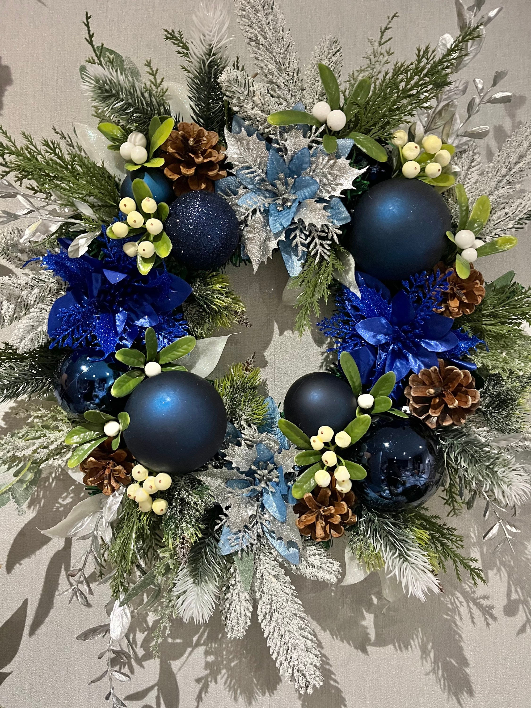 Blue and silver Christmas wreath with pine cones