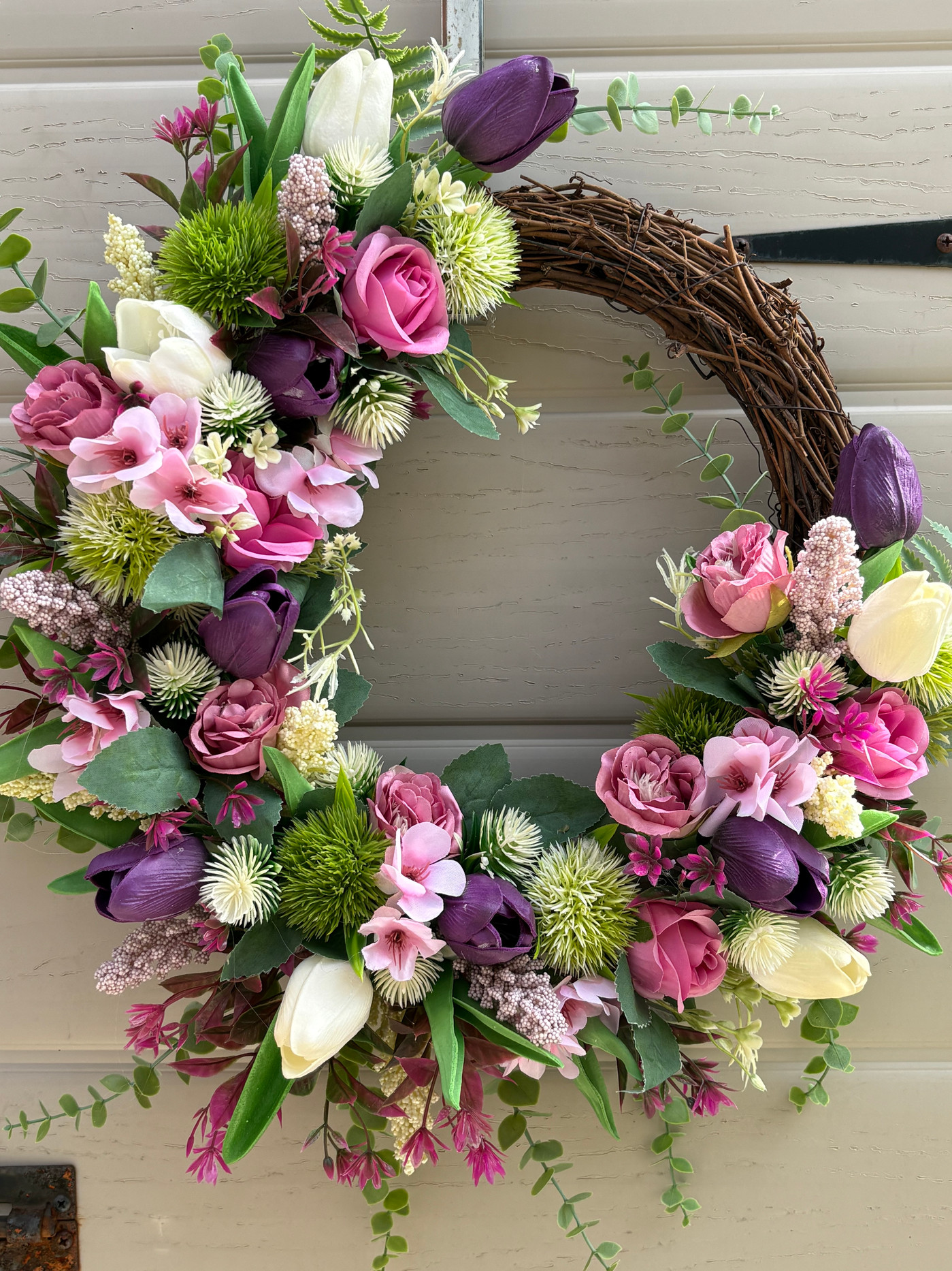 Handmade Blake mixed spring wreath on a vine base with tulips and dandelions