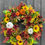 Thumbnail: Autumnal half wreath with sunflowers, pumpkins, and roses