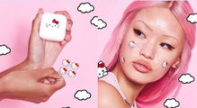 Pink-haired person with Hello Kitty Starface stickers on face, holding a Hello Kitty case and stickers . Pink background with white clouds.