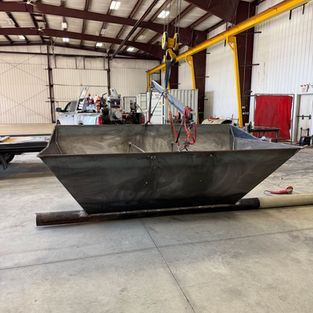 Custom steel material handling hopper fabricated from heavy-duty steel plate with tapered sides and reinforced construction for bulk material flow and industrial processing applications.