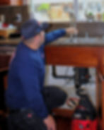 Technician performing professional drain cleaning service