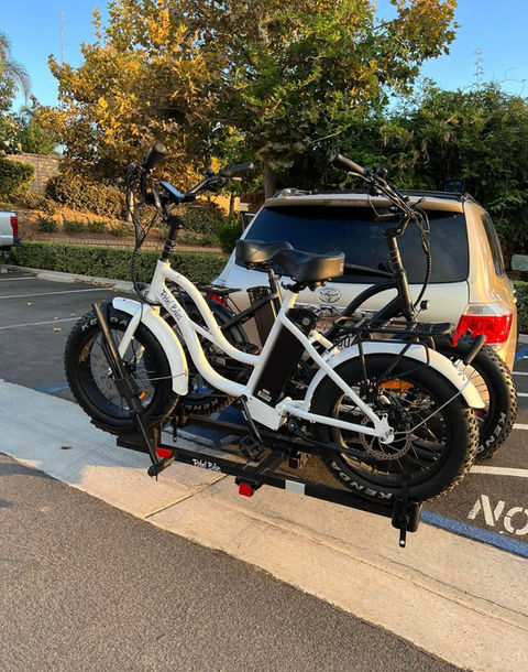 White e-bikes mounted on vehicle at Rebel Bikes.