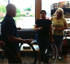 Tim Krone leads some KZoo women through changing a flat.