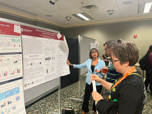 Lori and Adeeba present at the departmental retreat