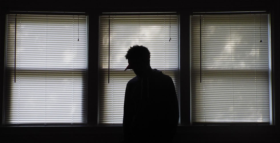 man standing infront of window blinds_ed