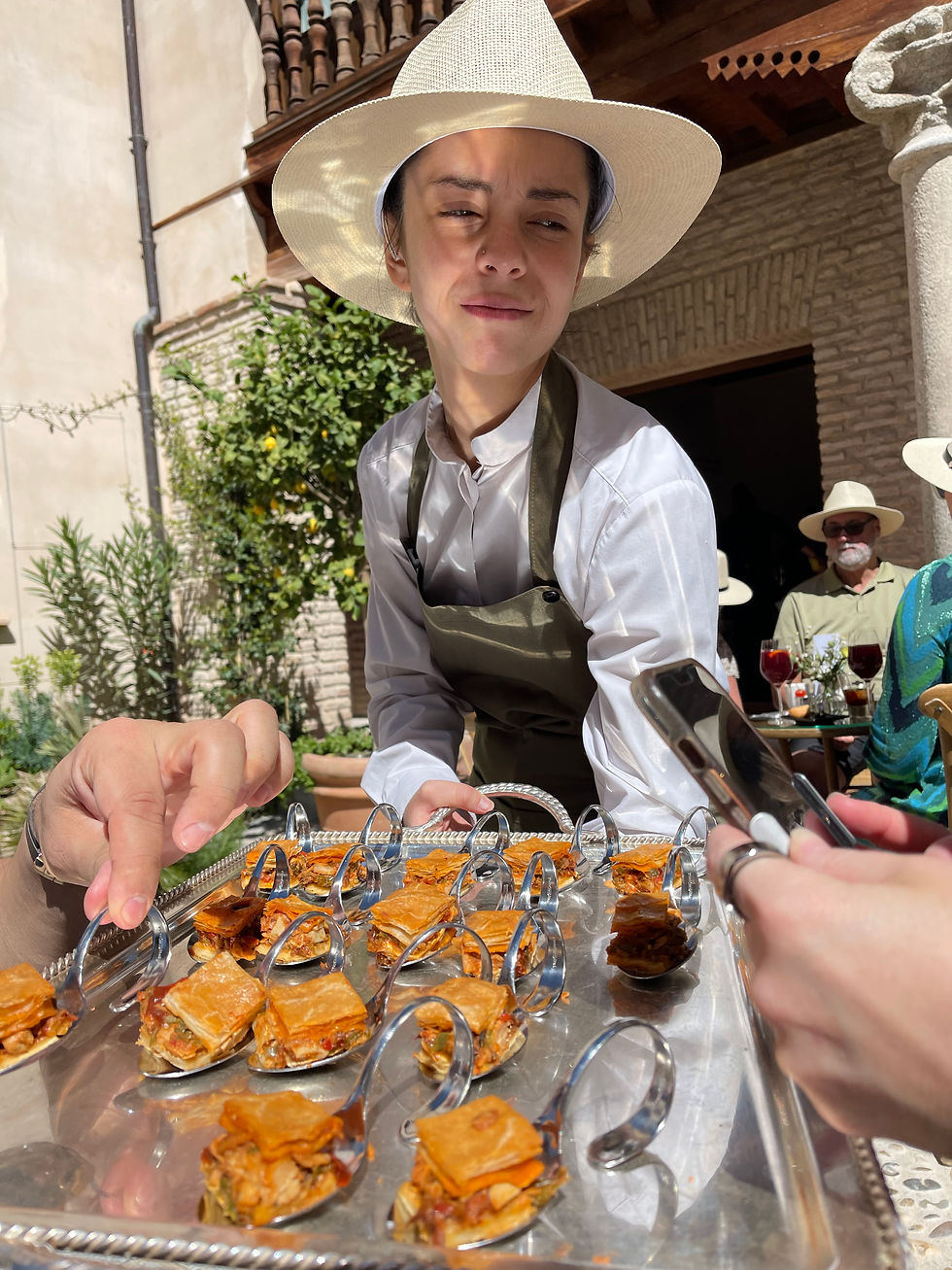 Toledo, Casa del Armiño, hospitality servers showcasting selicious típica Spanish food.