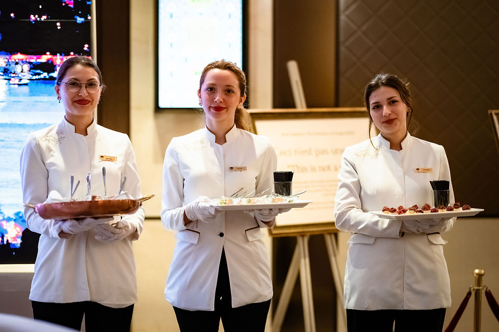 Team of Servers posing together, capturing hospitality at Mandarin Oriental Madrid. Professional hospitality pride.