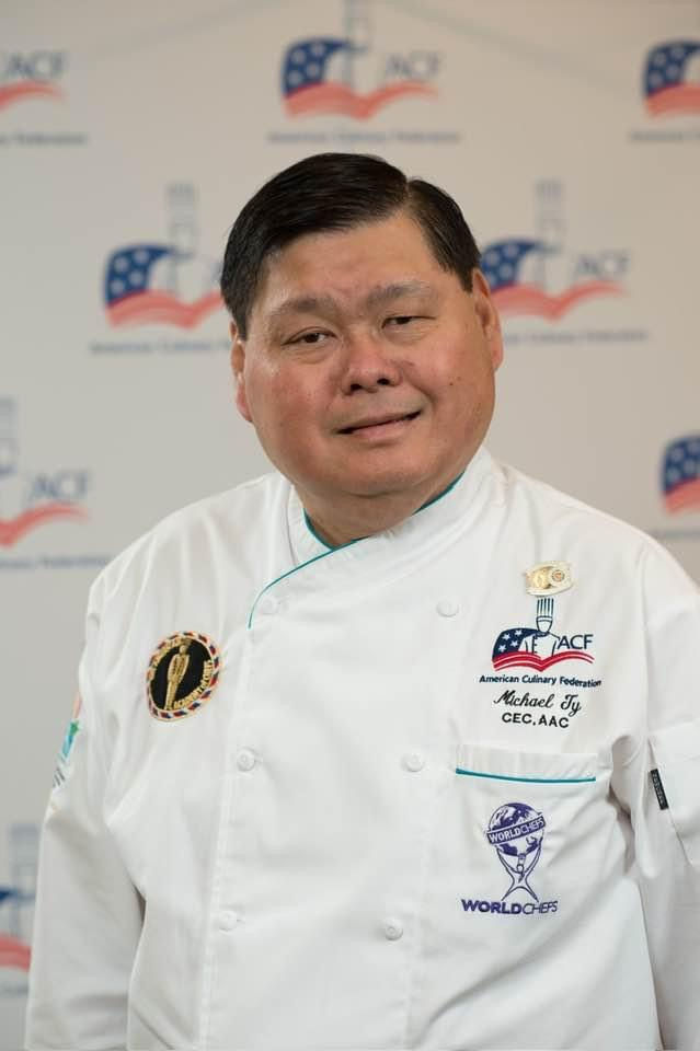 Portrait of the head chef in uniform, Mike Ty showcasing culinary leadership and excellence.p