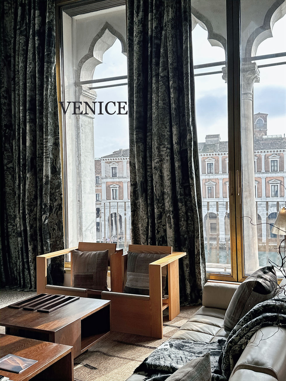 Elegant lounge with Venetian Gothic windows overlooking Venice, featured in VERVE and You travel edition