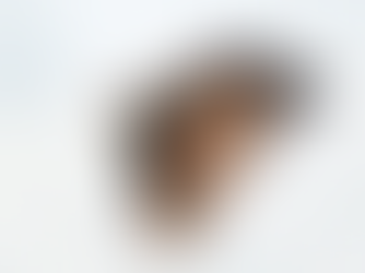 Woman peacefully sleeping on a white pillow and blanket. Soft lighting and serene expression, suggesting a calm and restful mood.