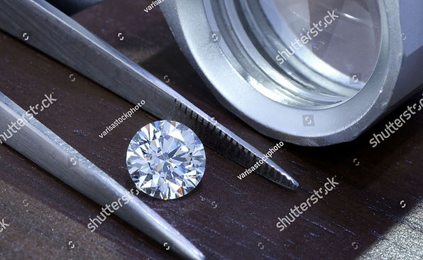 stock-photo-diamond-with-tweezers-and-ma