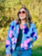Lindsey wearing a handmade faux fur jacket in bright blue and pink.