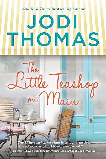 Book cover for "The Little Teashop on Main" by Jodi Thomas. Features a teashop with pastel chairs, a blue door, and a yellow-striped awning.