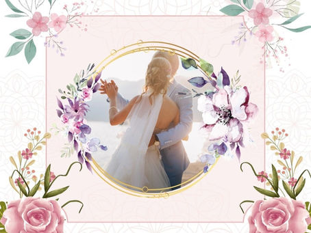 A couple embraces in wedding attire against a scenic backdrop, framed by pink and purple floral designs. Romantic and celebratory mood.