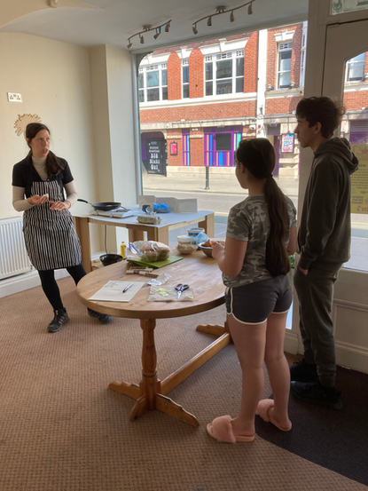 Wild Weed Kitchen workshop: instructor and students learning