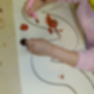 preschooler painting with rubber worm