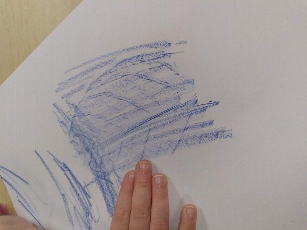 preschooler making a leaf rubbing