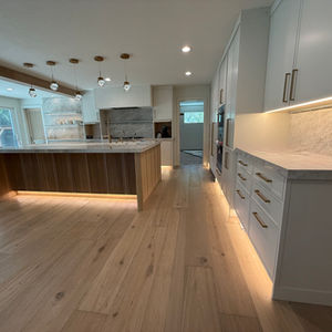 Modern kitchen with wood and white cabinetry.