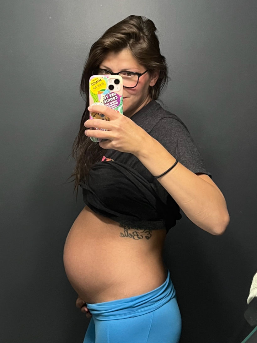 Pregnant surrogate taking a mirror photo during her surrogacy journey, reflecting the experience and ready to support anyone wanting to become a surrogate