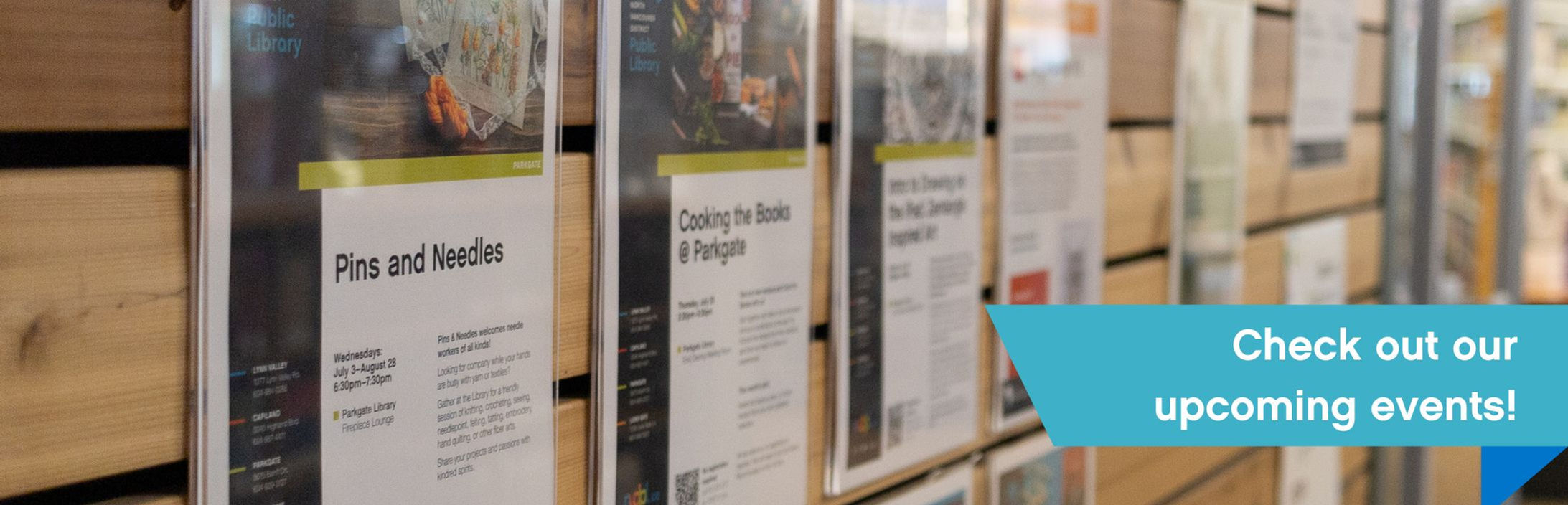  An angled shot of a wall with library event posters