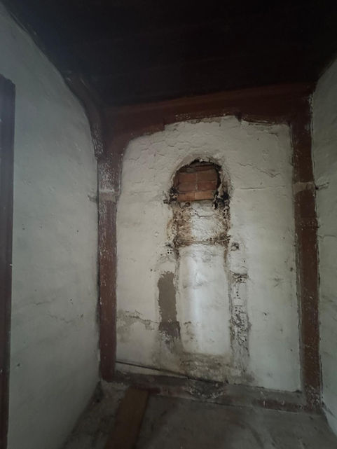 Interior of an authentic house for sale near Vasiliki with a stone wall and an ancient niche