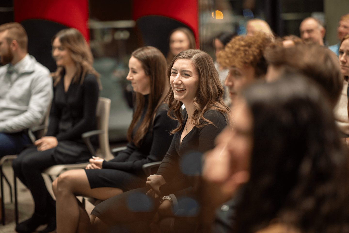 A group of student smiling in a crowd.