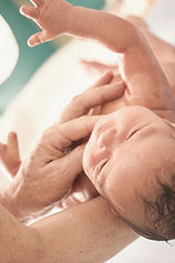 Siblings holding baby