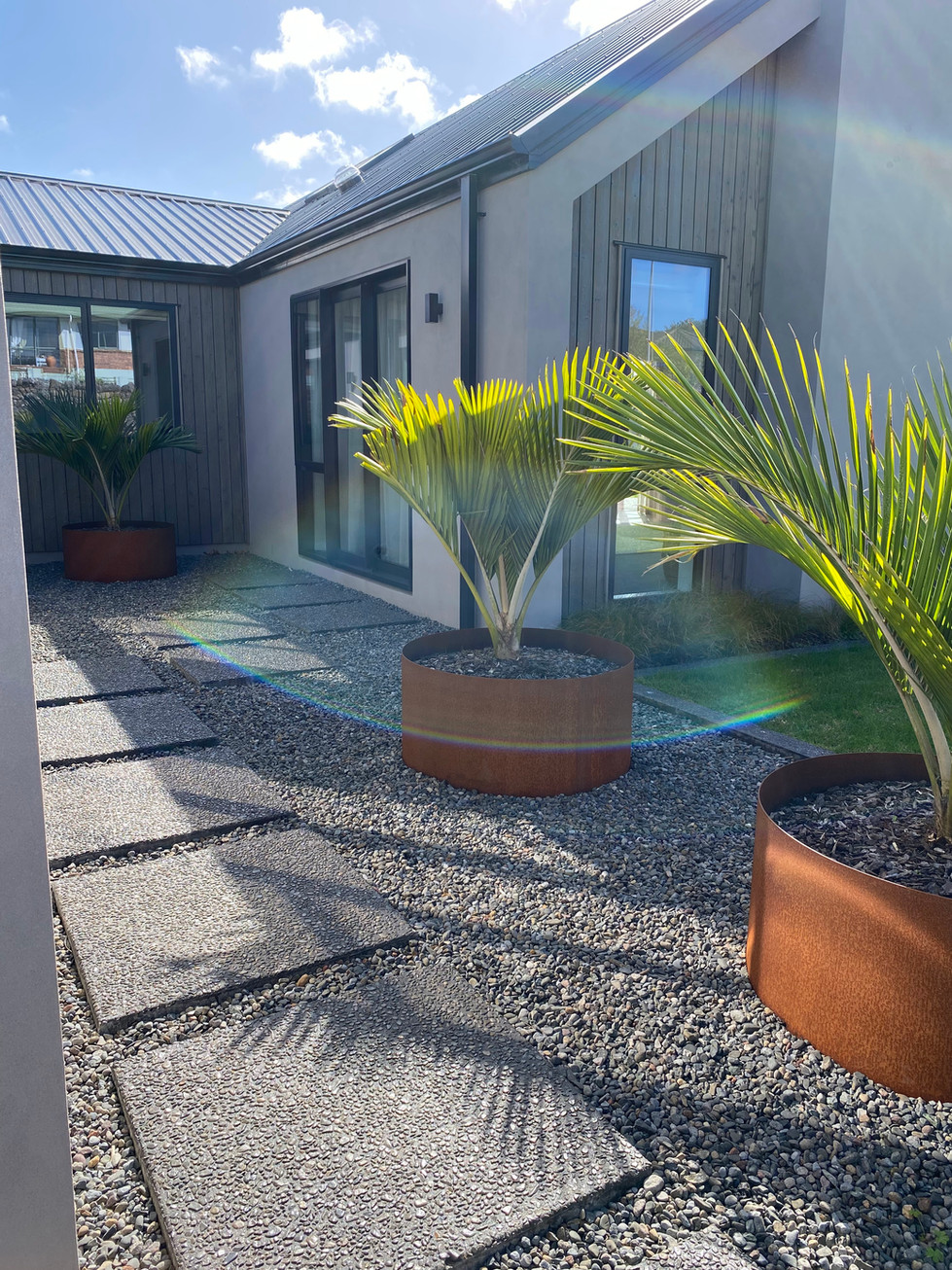 Exposed Awatoto Pebble, with 10kg black oxide. Concrete sealed. Pavers.