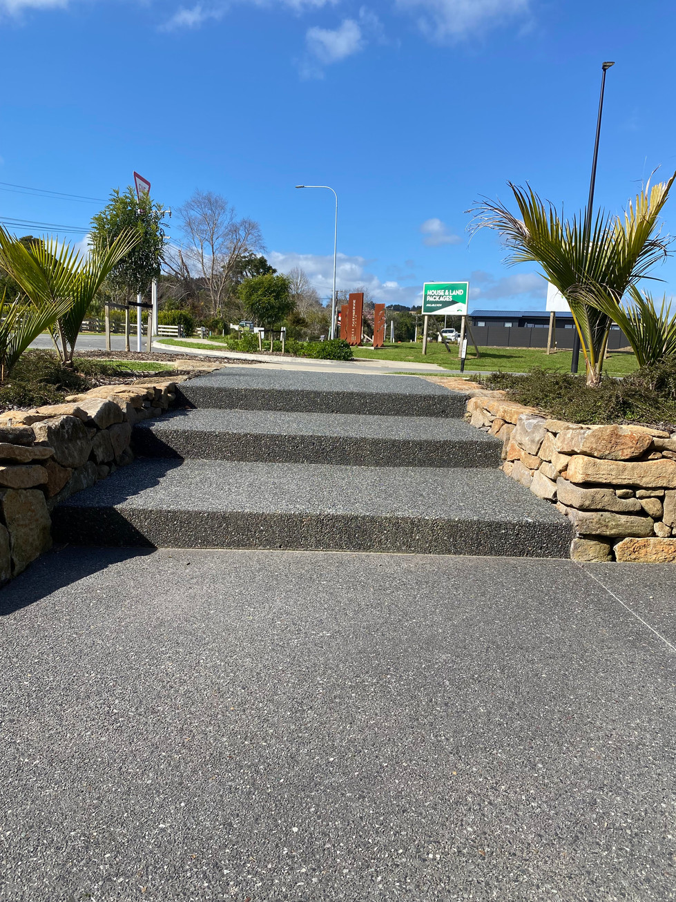 Exposed aggregate, with 5kg black oxide. Steps, stairs.