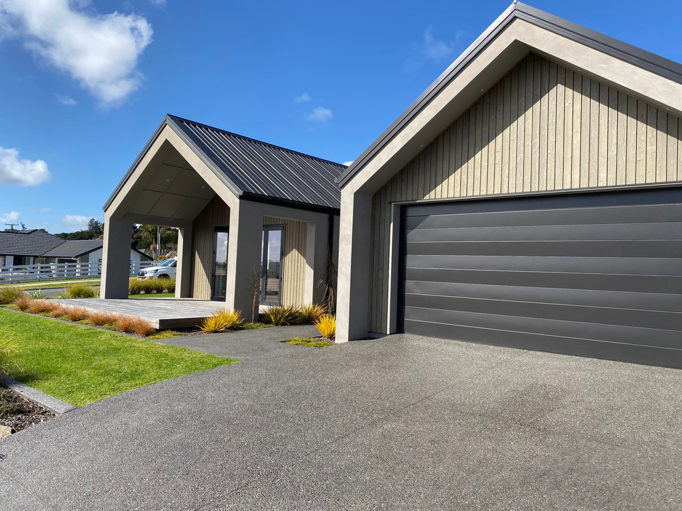 Exposed Awatoto Pebble, with 10kg black oxide. Concrete sealed. Driveway.