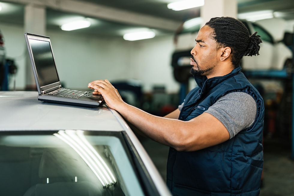 young-black-mechanic-using-computer-in-auto-repair-2024-12-13-22-13-37-utc (1).jpg
