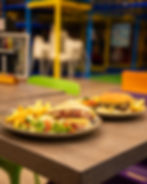 Parents relaxing in the café while children play at Rugrats & Halfpints Cirencester